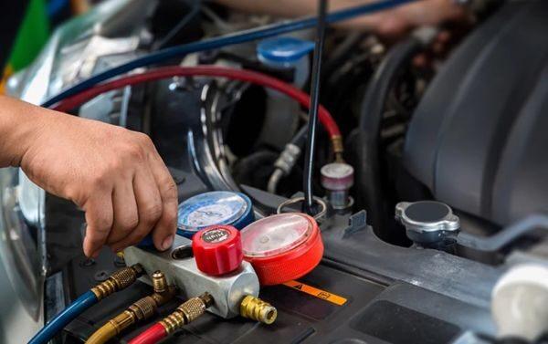 Mechanic performing AC compressor repair on a car or truck in San Antonio TX